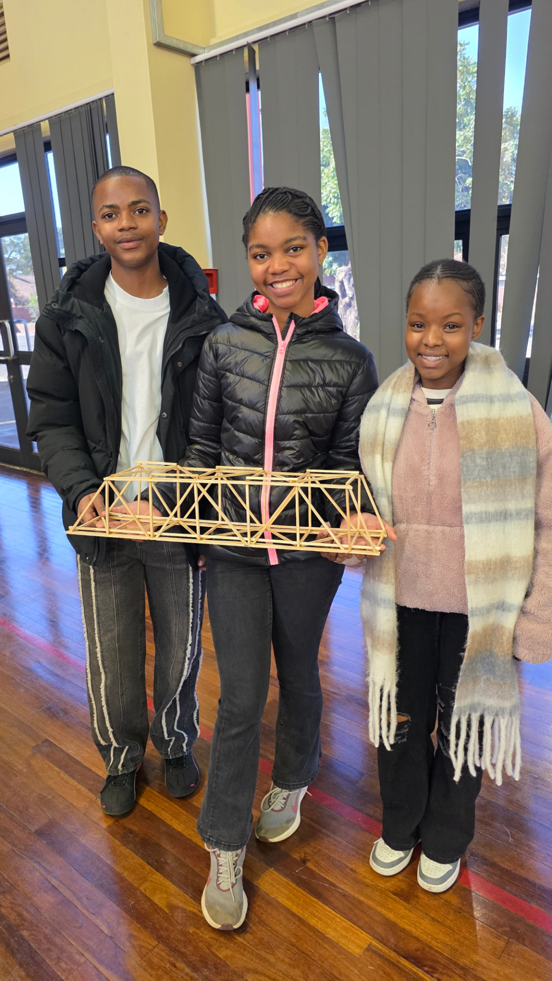 The PROTEC PMB Grade 11 team proudly holding the model bridge they built for the SAICE Bridge Building competition