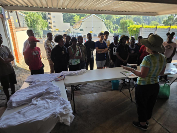 Mrs Cornel de Koker teaching Grade 10 students about pigments, the Colour Wheel, dyes and patterns during the Fabric Design T-shirt Tie/Dye workshop at Vac School